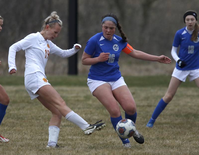 Richmond-Burton's Layne Frericks  takes a hot at the goal in front of Woodstock's Natalie Morrow during a Kishwaukee River Conference soccer match Wednesday, April 30, 2022, between Richmond-Burton and Woodstock at Creekside Middle School.