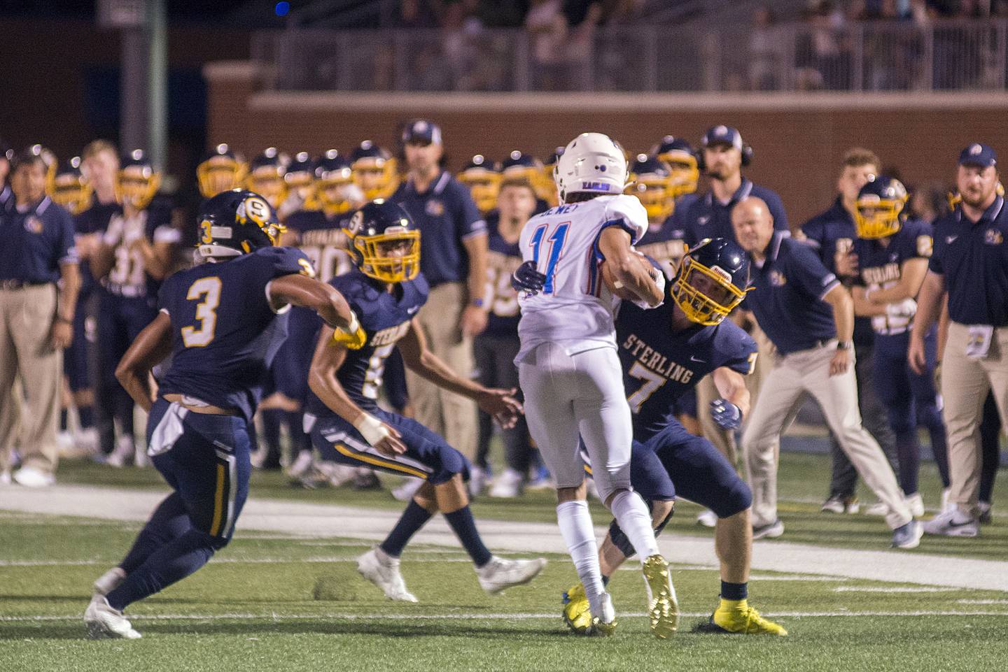 A host of Sterling tacklers take down Lakes’ Tyson Dewey Friday, Aug. 26, 2022.