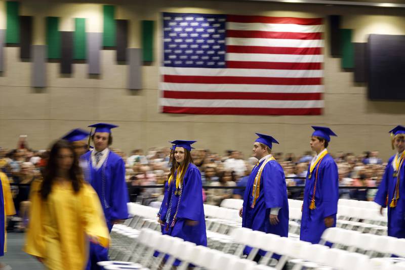 Wheaton North High School graduates stream into graduation ceremony Saturday, May 25, 2024 in the Physical Education Center of College of DuPage in Glen Ellyn.