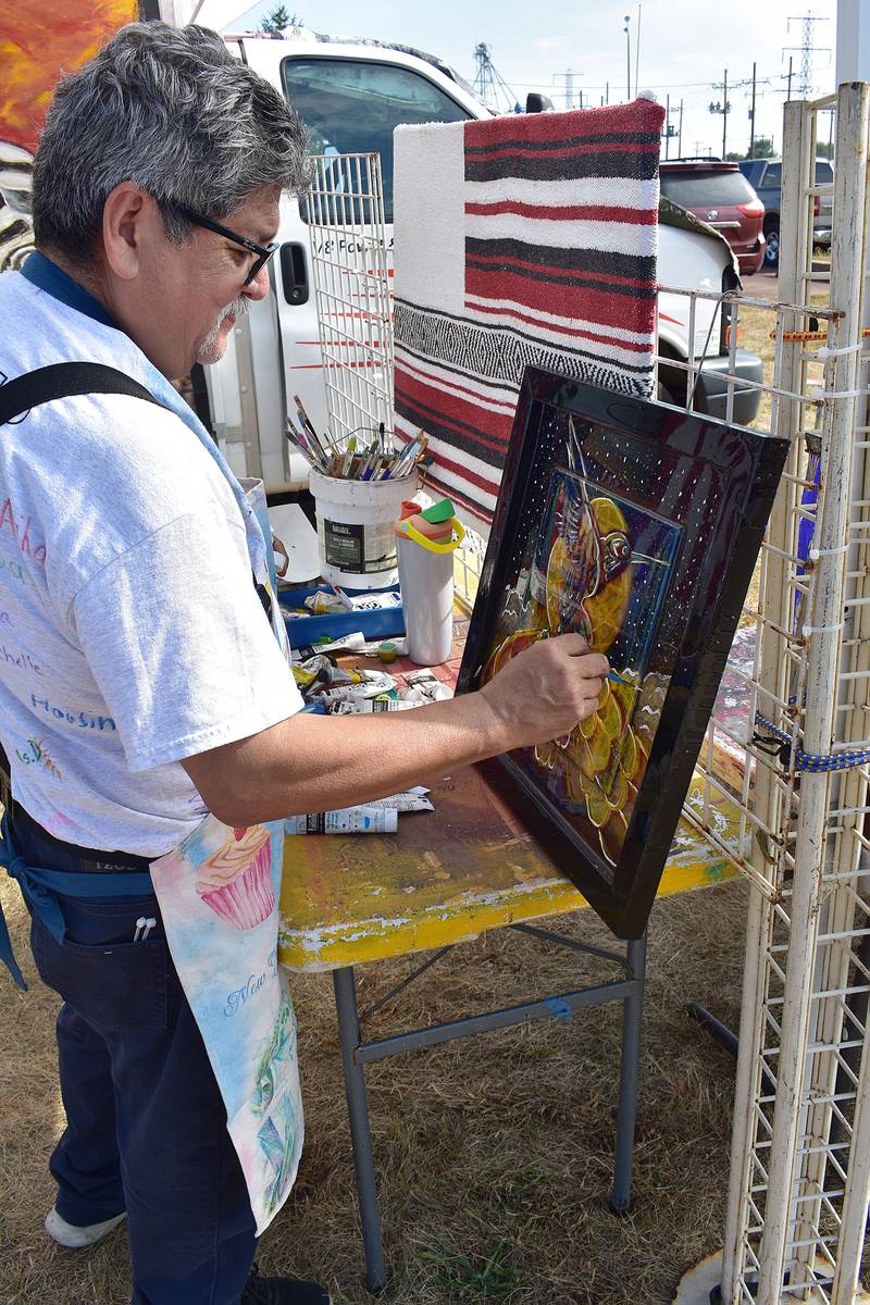 Sterling-Rock Falls native Victor M. Monanez of Logan Square paints a mural called "Flight of the Hummingbird” on Saturday, Sept. 13, 2025.