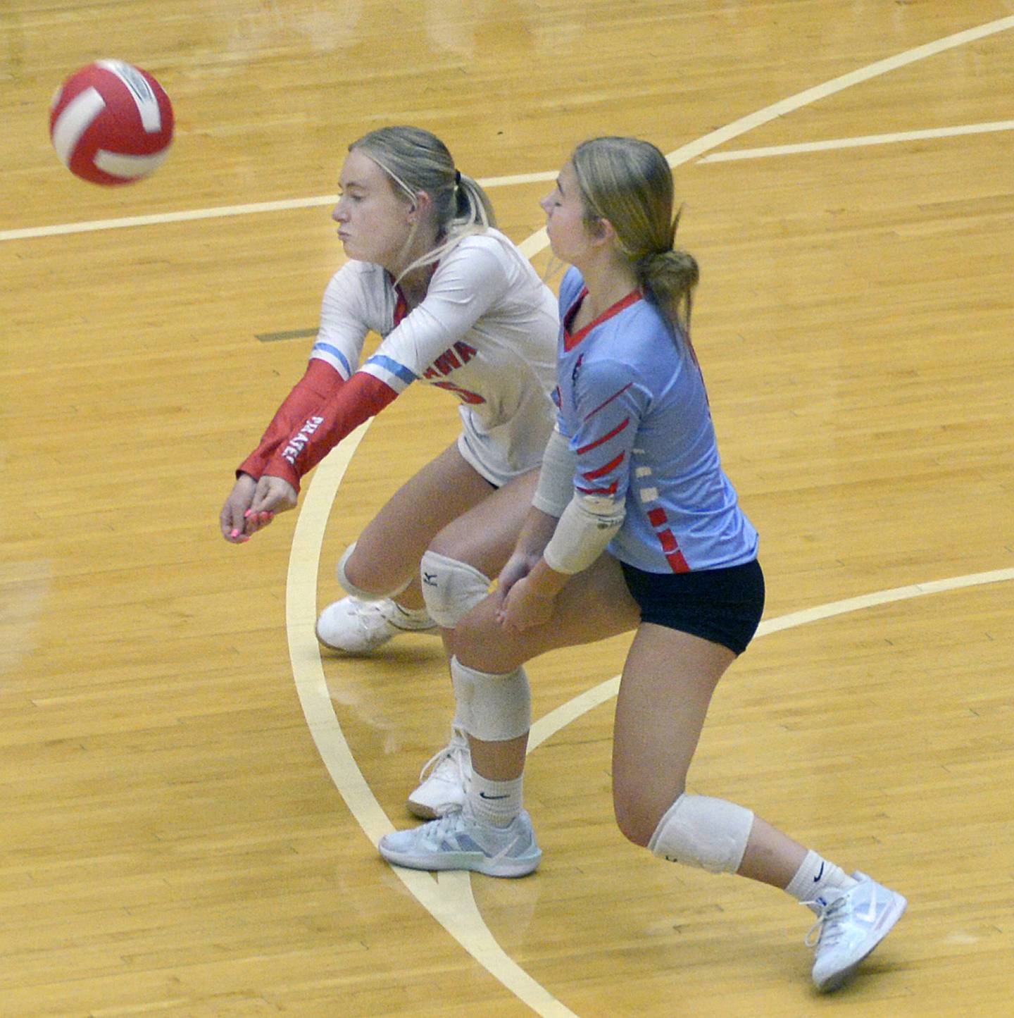 Ottawa’s Jordan Allen and Kendall Biba converge on returning a serve from Morris during the 1st set Tuesday at Ottawa.