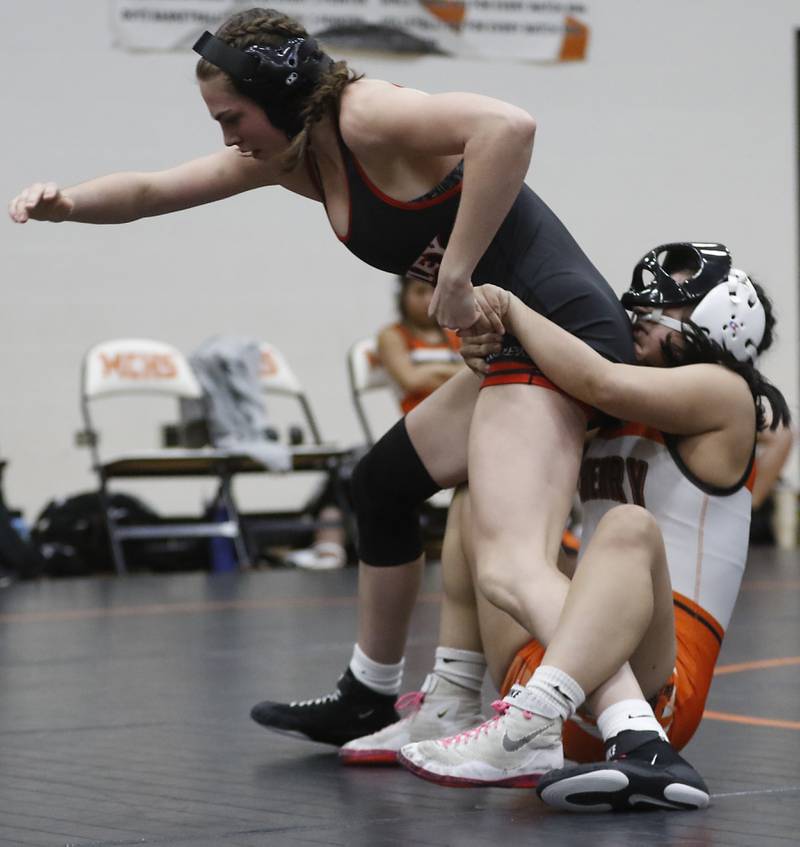 McHenry’s Natalie Corona tries to take down Huntley’s Jessica Olson during the 140-pound match of a Fox Valley Conference girls wrestling match Thursday, Jan. 11, 2024, at McHenry High School.