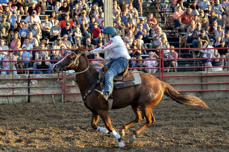 Ellen Inman heads for the finish in the barrel racing event Thursday, August 7, 2025, at Carroll County Fair’s T and A Bucking Bulls Rodeo.