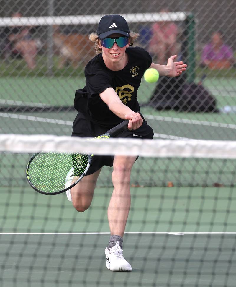 Sycamore number two singles player Luke Curtis comes to the net Thursday, April 24, 2025, during their match against DeKalb at Sycamore High School.