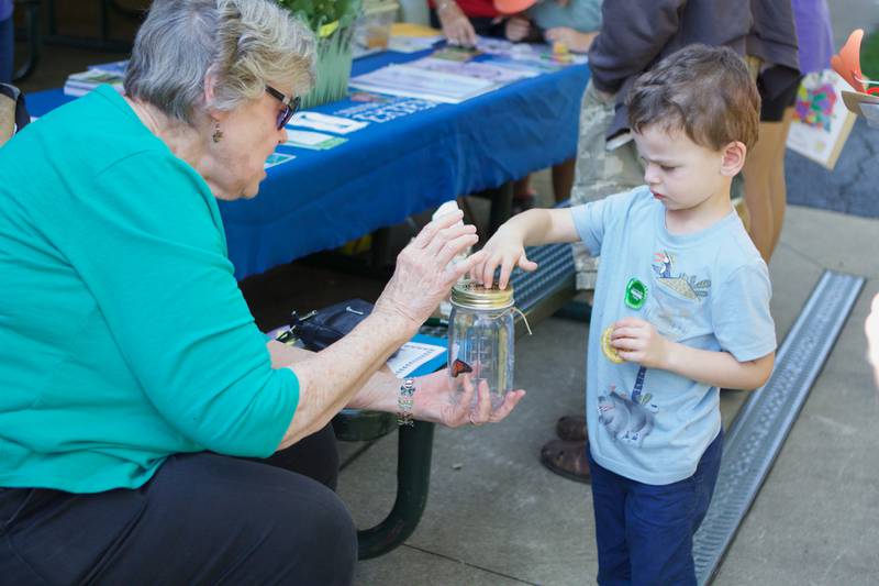 Kid's enjoy a Monarch in a jar at Westmont Library Moanarch Festival at Ty Warner Park on Saturday, Sept. 23,2023 in Westmont.