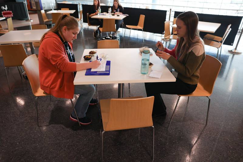 Chloe Ribley (left), a Junior at Eisenhower High School in Decatur, samples and rates a dish as Janella Winter, of the USDA, tries another dish at a nutritional and wellness event hosted by Joliet Junior College on Friday, April 21, 2023 in Joliet.
