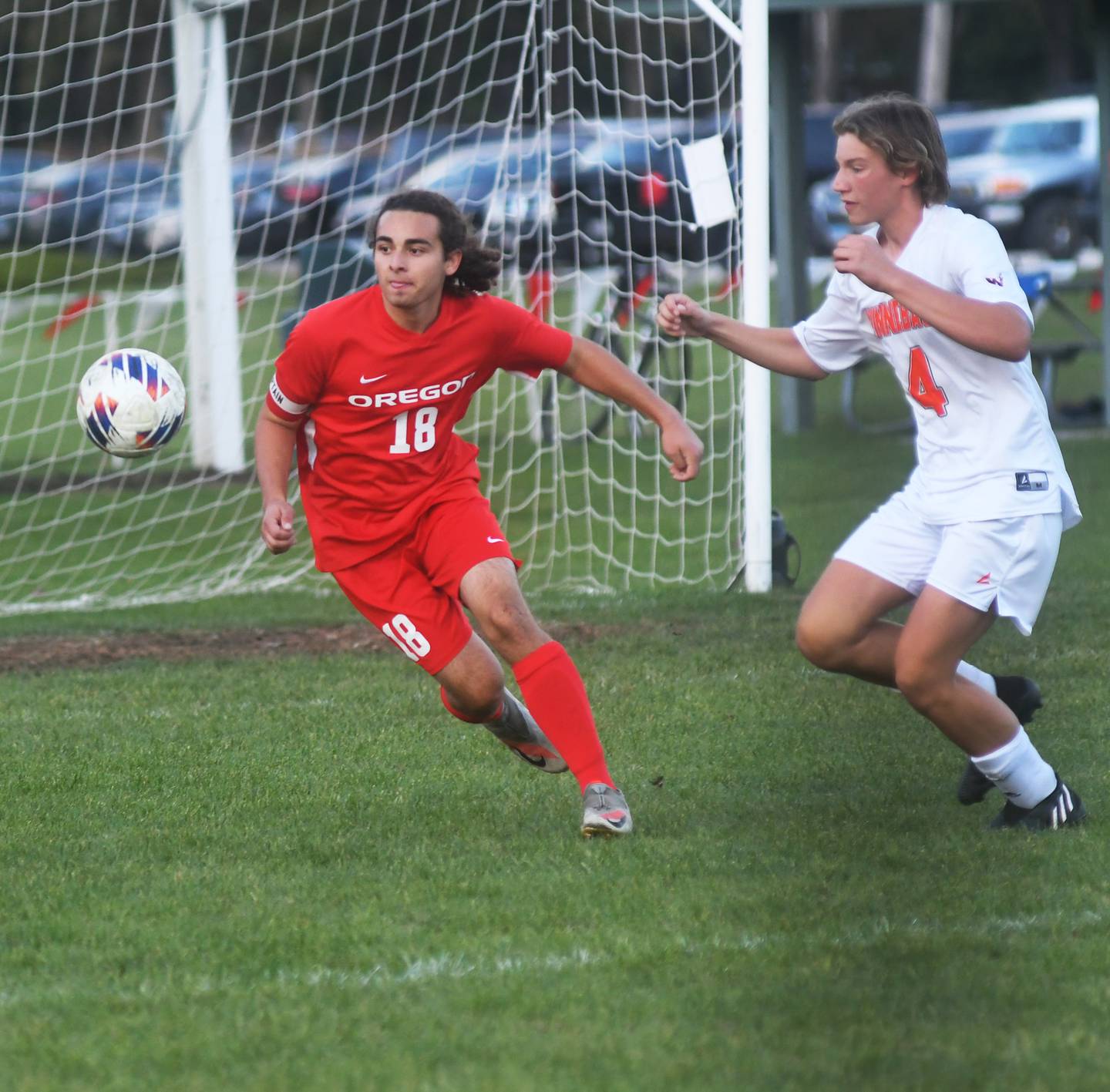 Oregon defender, Kyle Brechon (18), plays the ball away from Winnebago's Van Rumery during Class 1A regional action in Oregon on Wednesday.