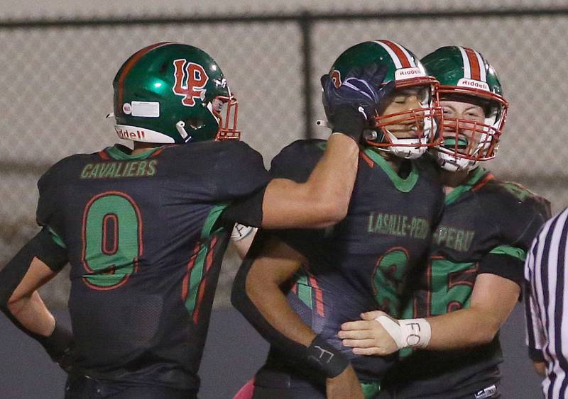 L-P's Jaron Morscheiser, Marion Persich and Beau Lawrence celebrate in the end zone after scoring a touchdown against Ottawa on Friday, Oct. 3, 2025 at Howard Fellows Stadium.