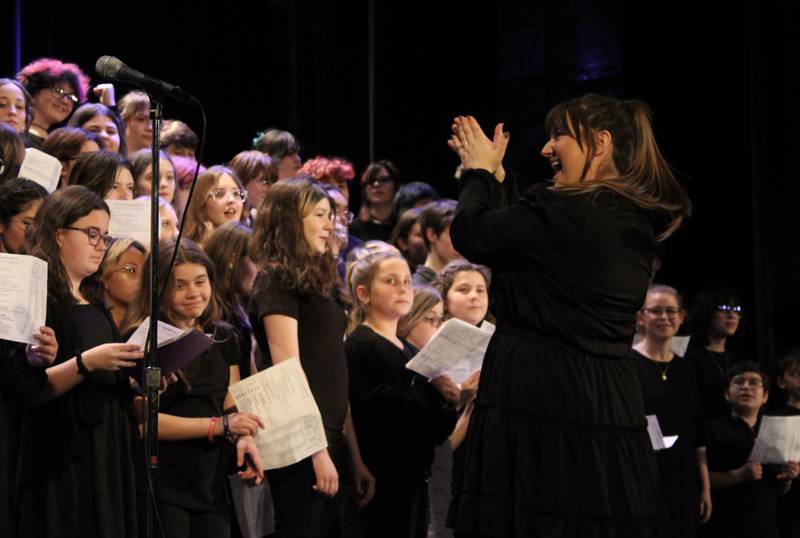Dixon High School choir director Erin Rogers congratulates the 140 members of the combined choir from Madison, Reagan and the high school after its performance on Friday, March 3, 2023, at Wiltz Auditorium in Dixon.