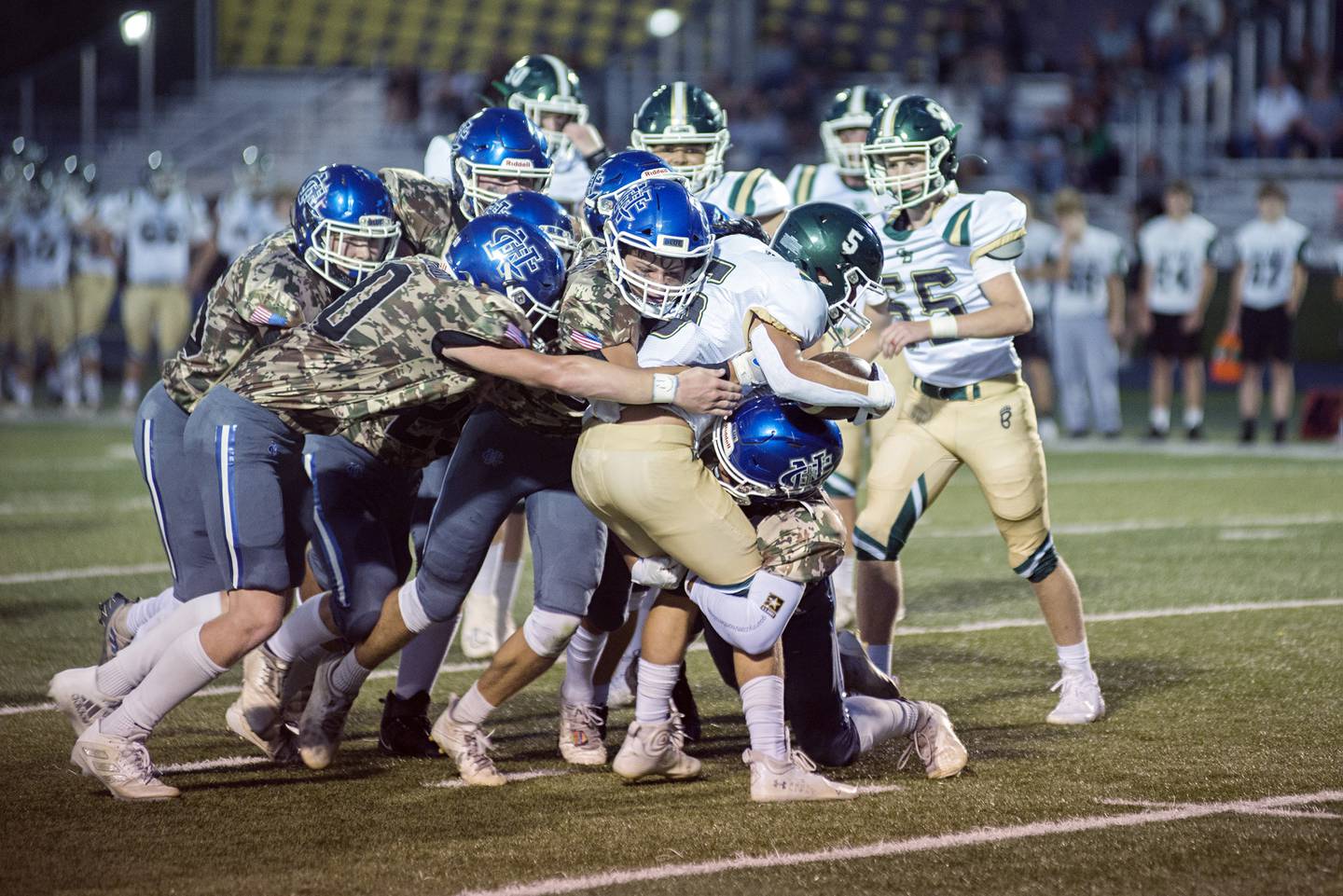 The Newman defense stops St. Bede back Callen Hueneburg Friday, Sept. 16, 2022.