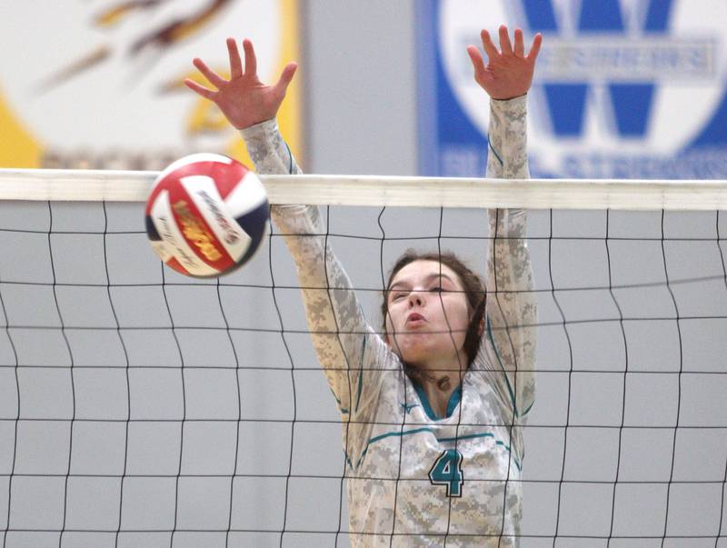 Woodstock North’s Avari Howard blocks against Woodstock in varsity volleyball at Woodstock North Monday night.