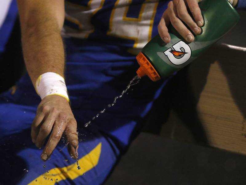 Johnsburg's Blake Hiller sprays water onto his finger during a IHSA Class 4A second round playoff football game Friday, Nov. 4, 2022, between Johnsburg and Rochelle at Johnsburg High School in Johnsburg.