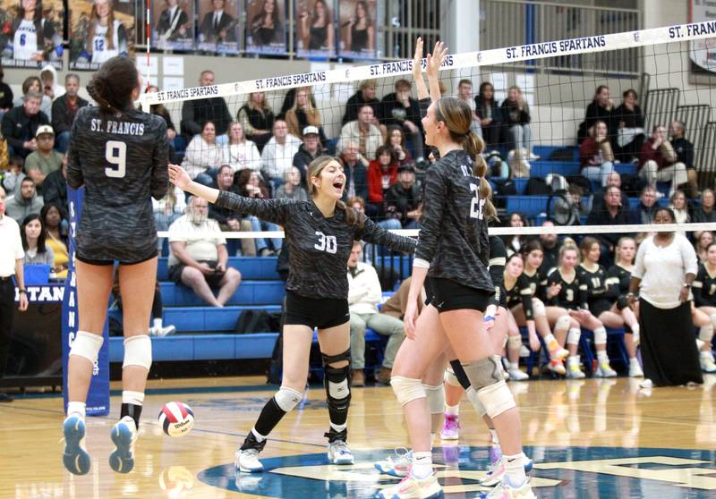 St. Francis players including Shay McMillen (center) celebrate their Class 3A St. Francis Sectional Semifinal win over Sycamore in Wheaton on Monday, Oct. 30, 2023.