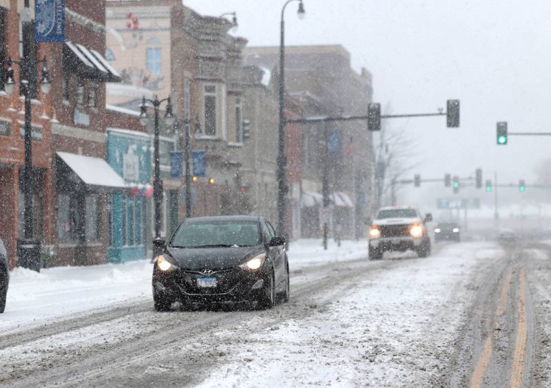 Cars travel through the snow down Lincoln Highway Saturday, Nov. 29, 2025, in DeKalb.