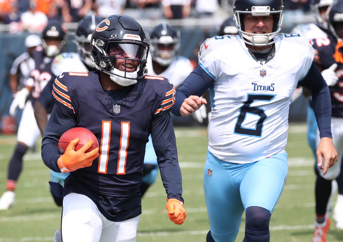 Chicago Bear kick returner DeAndre Carter picks up big yardage on a kickoff as Tennessee Titans place kicker Nick Folk pursues him during their game Sunday, Sept. 8, 2024, at Soldier Field in Chicago.