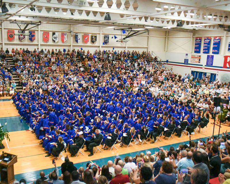 Graduates throw their caps in the air after graduating from Glenbard South High School on Thursday May 23, 2024, held at Glenbard South High School.