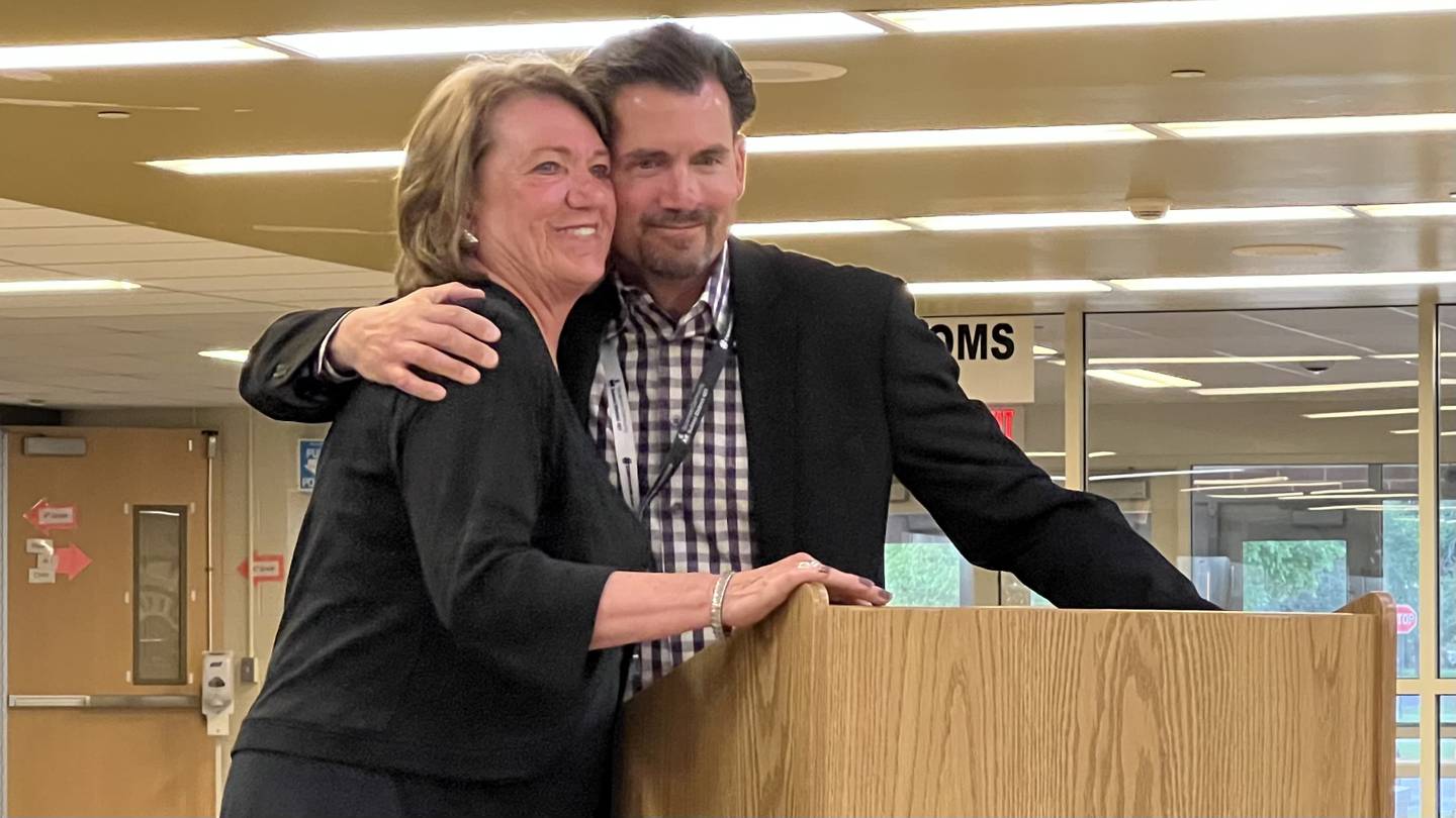 On May 23, 2023, Sycamore Community School District 427 Superintendent Steve Wilder hugs Donna Hill, a paraprofessional educator who is set to retire this summer after working for the school district for 51 years.