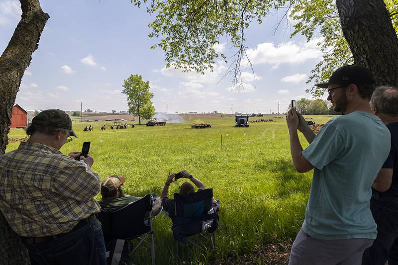Visitors take pictures and video Saturday, May 16, 2026, of the reenactment of the Battle of Anzio in Franklin Grove.