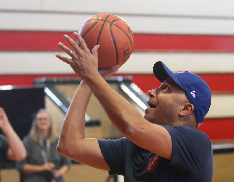 Tom Morello shoots a layup in the Marseilles Elementary School gymnasium after performing to the students on Thursday, Nov. 30, 2023. Morello is best known for his tenure with the rock bands Rage Against the Machine and Audioslave. Morello grew up in Marseilles before making it to the major music industry.