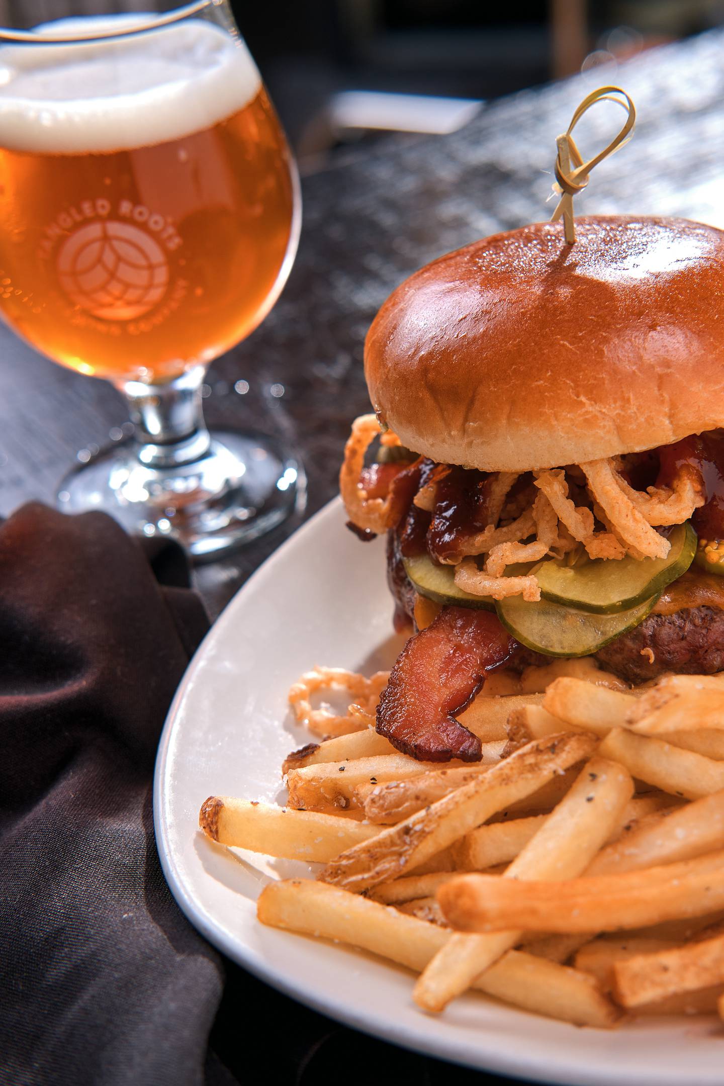This burger has Bourbon cherry barbecue sauce, bacon, aged cheddar, house pickles, frites aioli and crispy onions. Pair it with a Kit Kupfer Amber Ale.