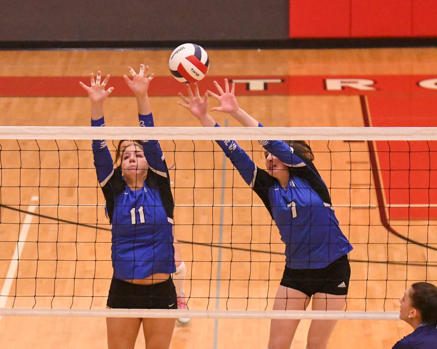 Geneva's Caitlyn Potvin (11) and teammate Jordan Davenport (7) try to block the ball during the sectional tittle game against Nazareth Academy held at Timothy Christian High School.