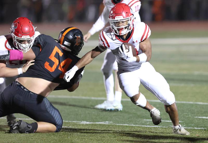 Naperville Central's Caleb Brown gets past DeKalb's Nathan Hoard during their game Friday Oct. 7, 2022, at DeKalb High School.