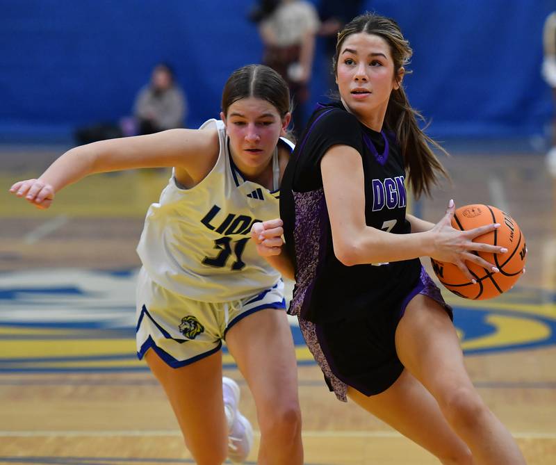 Downers Grove North’s Eva Yerkovich drives as Lyons Township’s Evie Riopell defends during a game on January 10, 2026 at Lyons Township High School in LaGrange.
