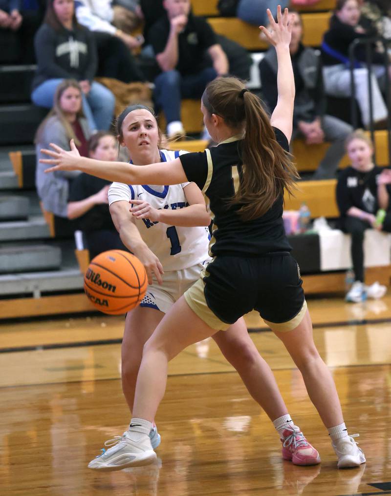 Burlington Central's Kelsey Covey passes the ball around Sycamore's Cortni Kruizenga Thursday, Feb. 19, 2026, during their Class 3A regional championship game at Sycamore High School.