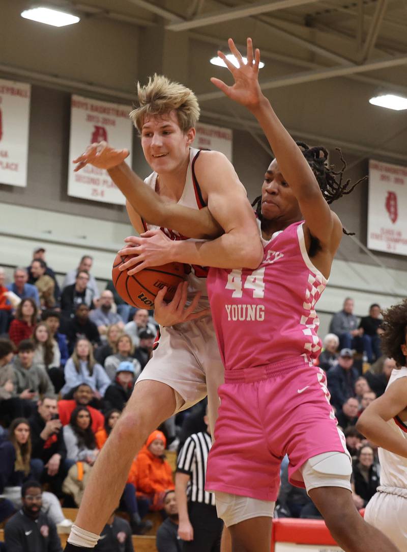 Yorkville’s Jason Jakstys (32) fights for the ball against Whitney Young’s Howard Williams (44) during the When Sides Collide Shootout on Saturday, Jan. 20, 2024 in Lisle, IL.