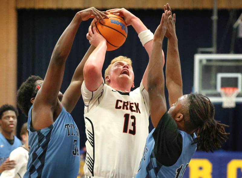 Indian Creek's Isaac Willis goes up for a shot between IMSA’s Lota Onwuameze (left) and Benjamin Dixson Friday, Feb. 6, 2026, during their Little 10 Conference championship game at Somonauk High School.