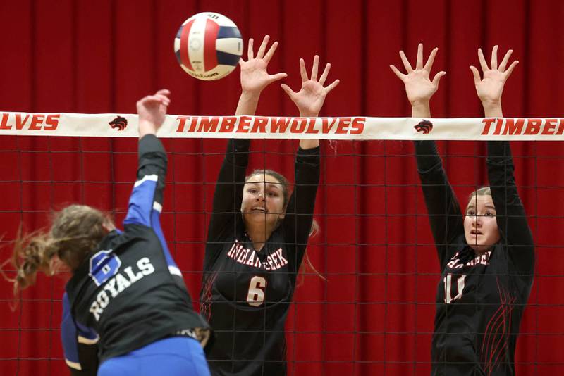 Indian Creek's Isabella Turner (left) and Ellie Bend try to block Hinckley-Big Rock's Courtlyn Brockway during their Class 1A regional play-in game Monday, Oct. 28, 2024, at Indian Creek High School in Shabbona.