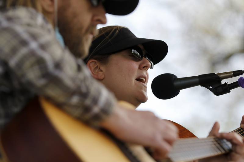 The band Courtney & Chris, comprised of Chris Kalkbrenner of Cary, left, and Courtney Sullivan of Woodstock, perform during the Woodstock Farmers Market on the Woodstock Historic Square on Saturday, April 17, 2021, in Woodstock. The market hours 8 a.m. to 1 p.m. Saturdays and starting, June 1, the same hours on Tuesdays.