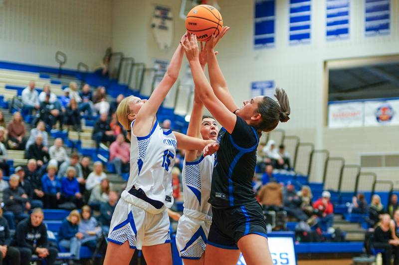 Geneva’s Emma Peterson (15) blocks a shot by St. Charles North's Riley Barber (44) during a game at Geneva High School on Thursday, Dec. 4, 2025.