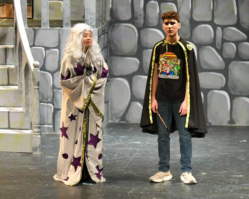 Downers Grove North students Quinn McCloud, who plays Wayne, and Stormy Fleener who plays the Second Headmaster, talk during the production of Puffs on Saturday Nov. 23, 2024, held at Downers Grove North’s High School auditorium.