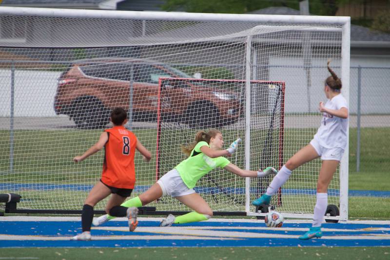 St. Charles East's Mia Raschke scores a goal past Wheaton North Goalie Zoey Bohmer at the Class 3A Regional Final in Wheaton on May 20,2022.