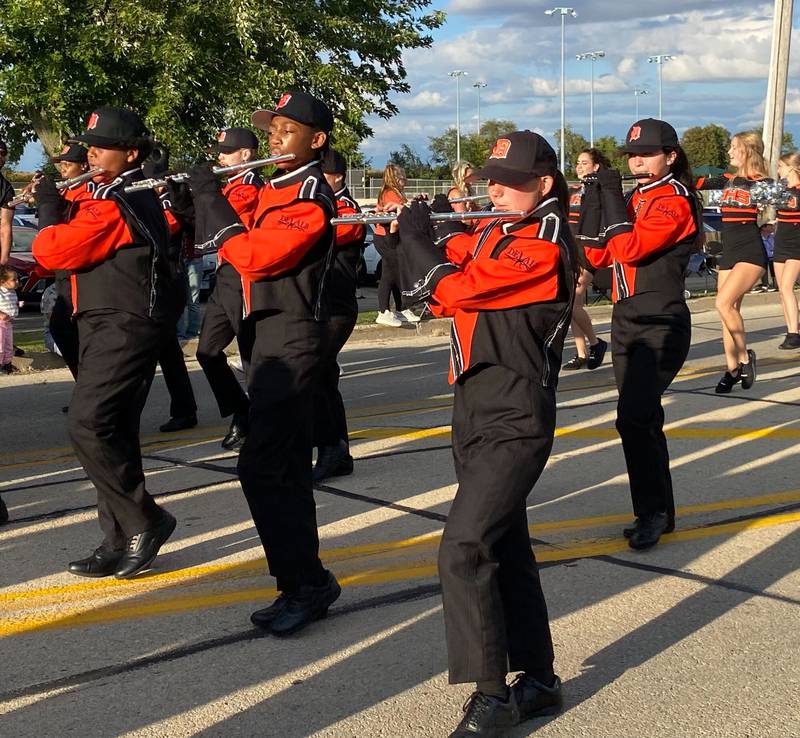 Flautists perform in the DeKalb Barbs Marching Band for the annual DeKalb High School Homecoming Parade on Wednesday, Sept. 24, 2025, along West Dresser Road.