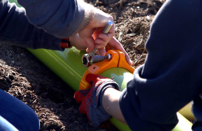 Volunteers and friends of Three Oaks Elementary School constructed a new playground at the Cary school on Saturday.