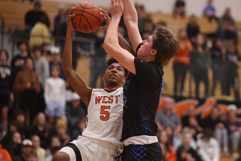 Lincoln-Way West’s Daniel Reniguntala goes in for the basket against Lincoln-Way East.