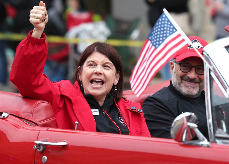 Northern Illinois University President Lisa Freeman leads the N-I-U chants as she rides in the March of the Huskies parade during the NIU Huskie Homecoming Block Party Thursday, Oct. 12, 2023, in downtown DeKalb.