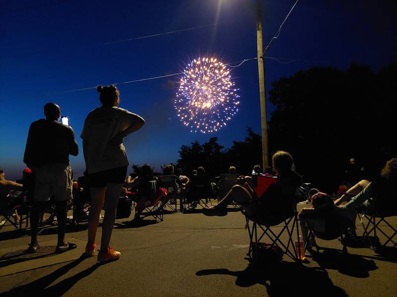 Spectators watch the Ottawa Independence Day fireworks Tuesday, July 4, 2023, from their lawn chairs where Prospect Avenue and Catherine Street intersect on the south banks of the Illinois River.