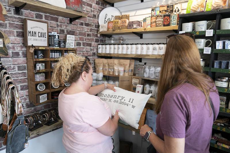 Cindy Smith and Tracie Palmer, both of McHenry, shop inside Vintage Mercantile Artisan Market during the grand opening and ribbon cutting of the new McHenry Riverwalk Shoppes in downtown McHenry on Friday, July 21, 2023.