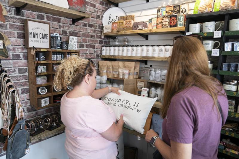Cindy Smith and Tracie Palmer, both of McHenry, shop inside Vintage Mercantile Artisan Market during the grand opening and ribbon cutting of the new McHenry Riverwalk Shoppes in downtown McHenry on Friday, July 21, 2023. Ryan Rayburn for Shaw Local