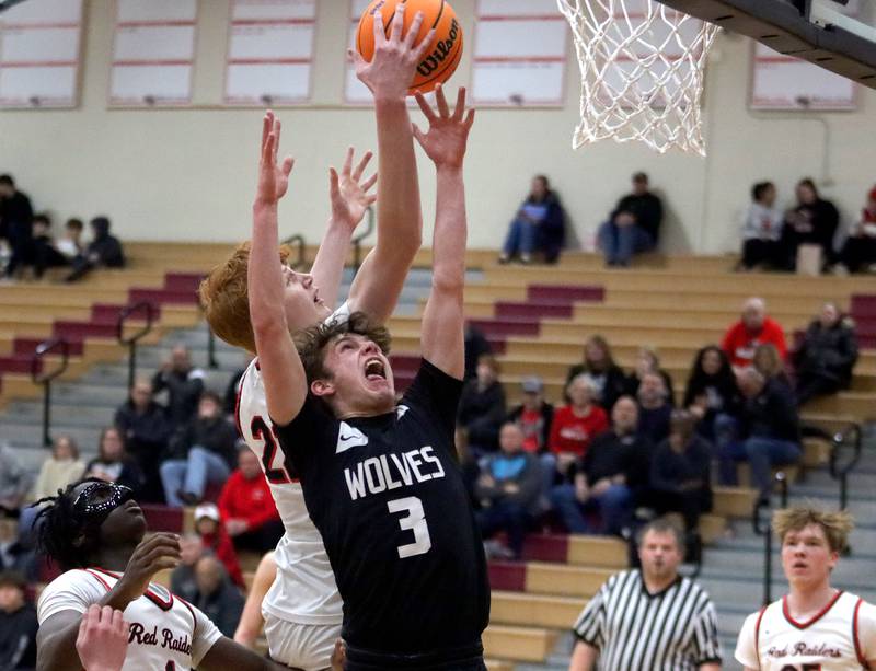Huntley’s Logan Darragh, back, battles Prairie Ridge’sRory Rezendes, front, in varsity boys basketball on Tuesday, Feb. 18, 2025, at  Huntley High School in Huntley.