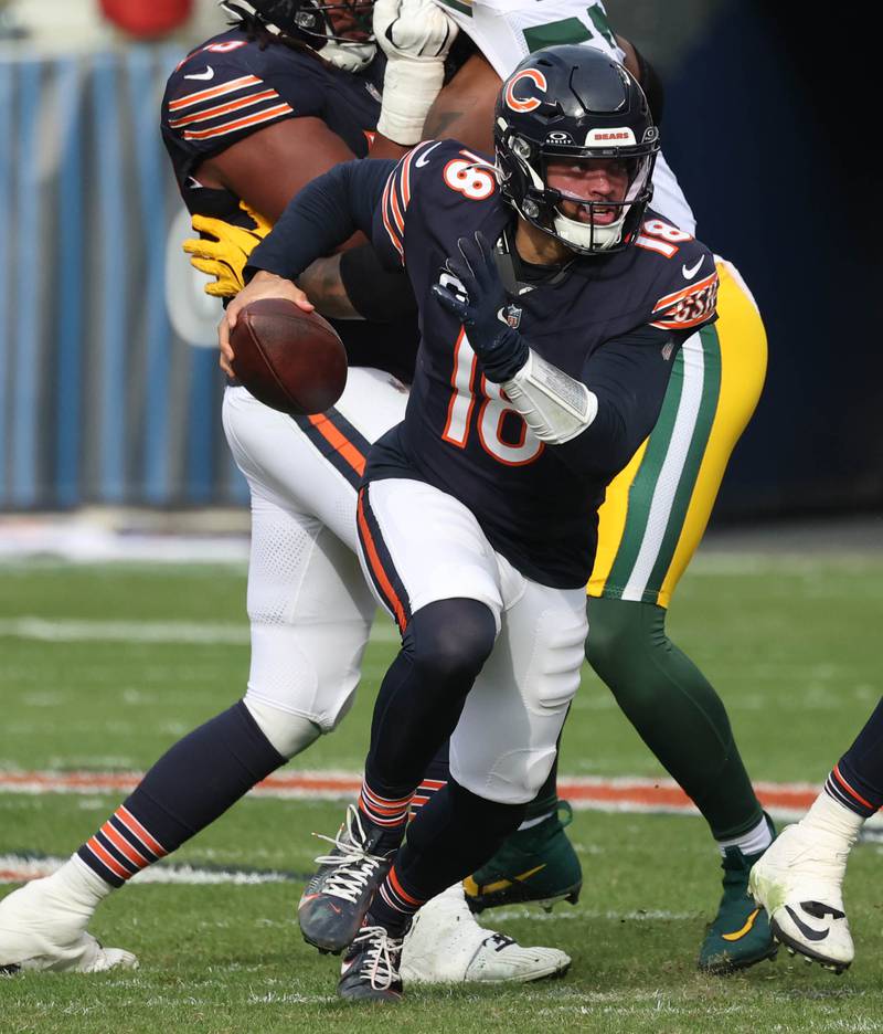 Chicago Bears quarterback Caleb Williams scrambles away from the Green Bay Packers pass rush for good yardage Sunday, Nov. 17, 2024, during their game at Soldier Field in Chicago.