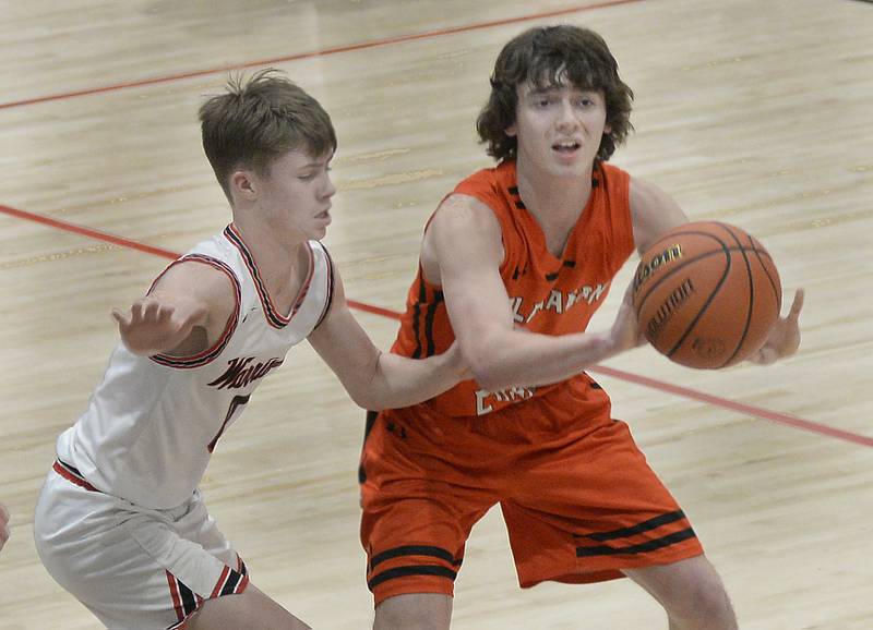 Flanagan-Cornell’s Connor Reed (at right) looks to pass while being defended by Woodland’s Carter Ewing in the first period on Wednesday, Feb. 15, 2023, at Woodland School.
