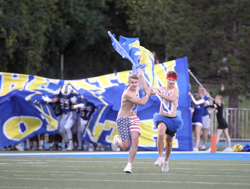 Wheaton North fans lead the players onto the field before a home game against Batavia on Friday, Sept. 9, 2022.