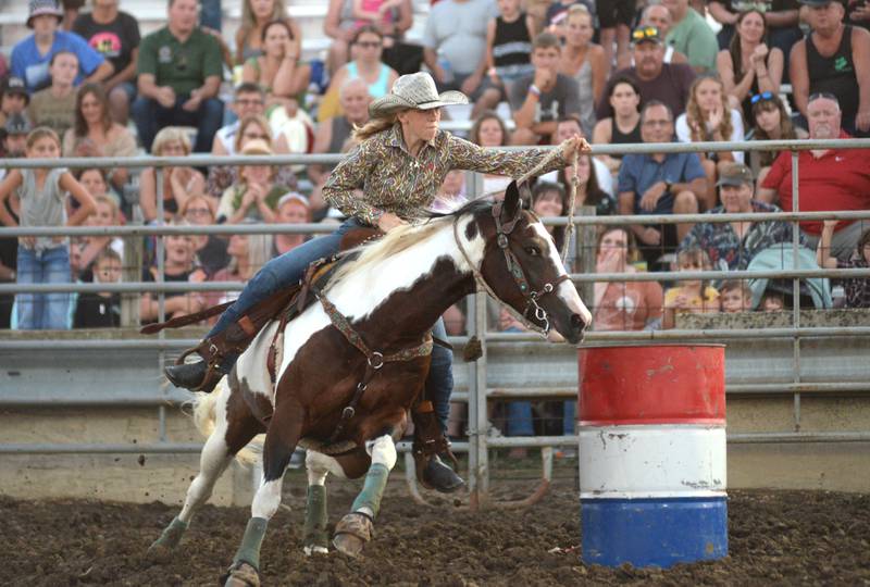 Quincy Hochstatter, 14, of Wyanet, steers her horse Katie around a barrel during the barrel races at the T and A Rodeo at the Lee County Fair on Saturday, July 29, 2023.
