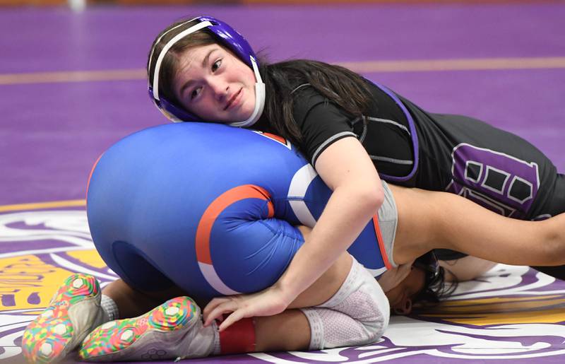 Dixon's Alana Lorenzen (left) looks to her coaches as she battles Genoa-Kingston's Marilu Mercado in  the 140 pound match for third place at the Belvidere Regional on Saturday, Feb. 7, 2026.