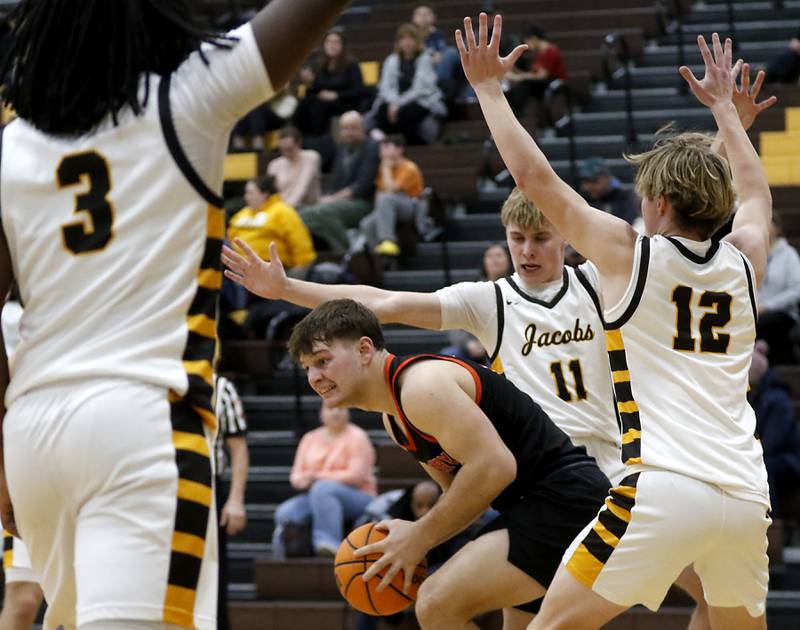 McHenry's Conner McLean tries to away from the pressure of Jacobs' Carson Goehring (center) and Connor Goehring (right) during a Fox Valley Conference basketball game on Friday, Jan. 24, 2025, at Jacobs' High School.