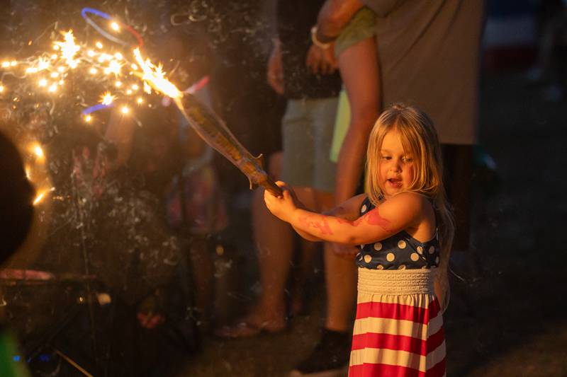 Amelia Jensen plays with sparkler at the annual 4th of July firework show on Friday, July 4, 2025 at River Front Park in Hennepin.